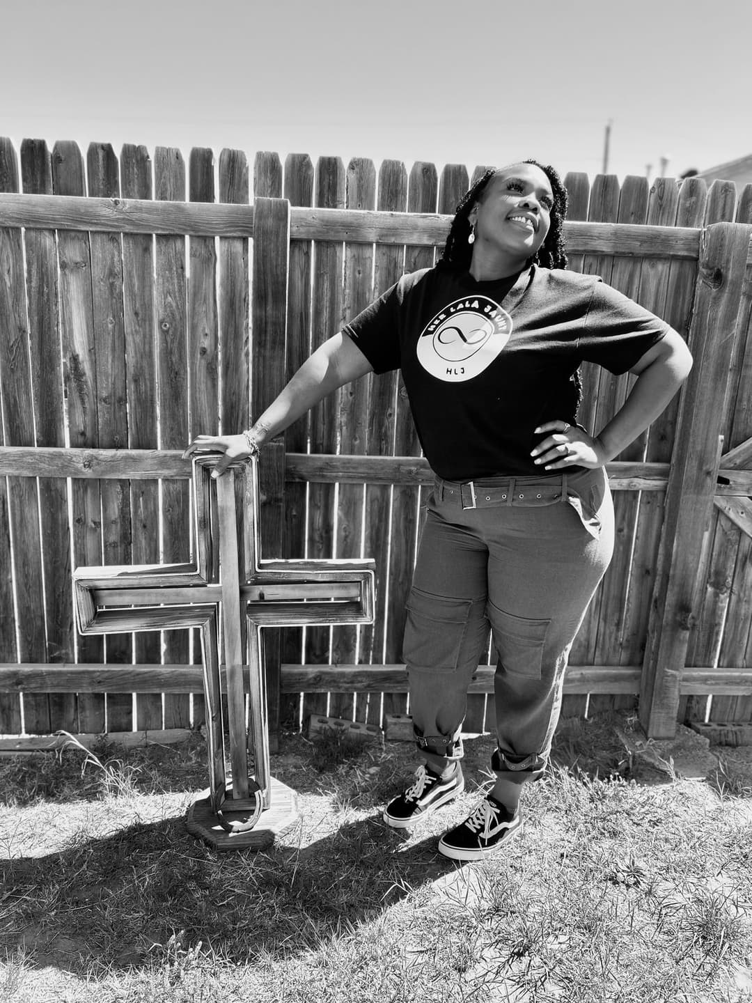 Heidi Johnson standing beside a wooden cross, faith at the center of her work
